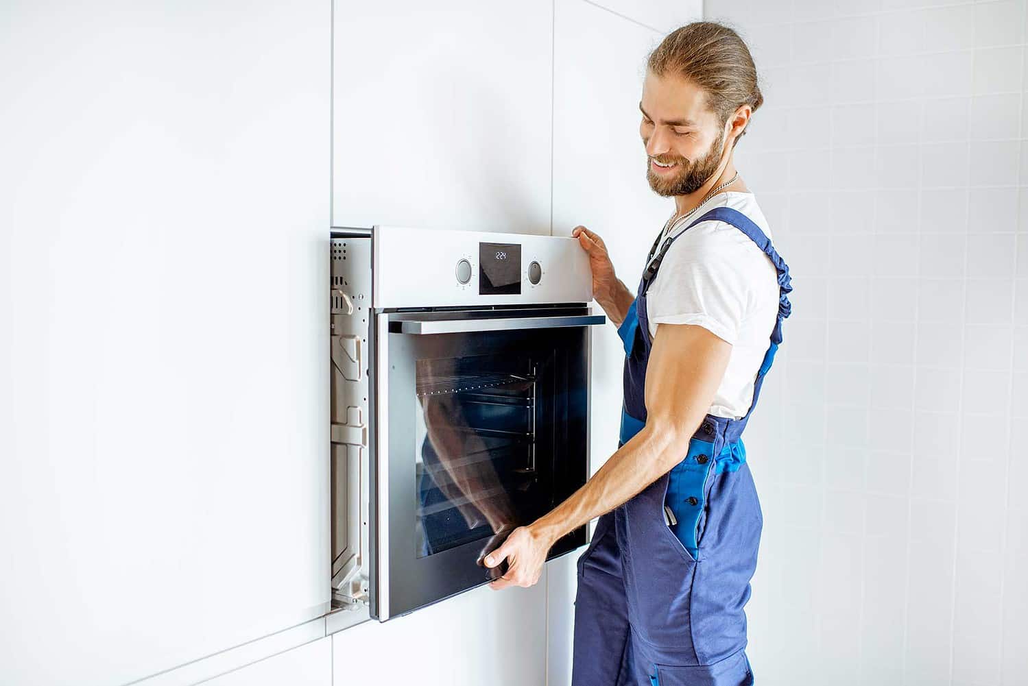 Appliance Installation Edmonton - Man installing an oven