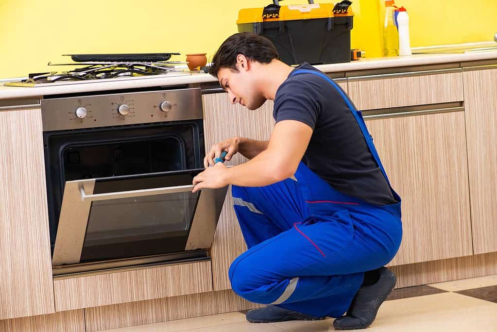 Mississauga Stove Repair Experts - Man Repairing stove - Dial an applianceman