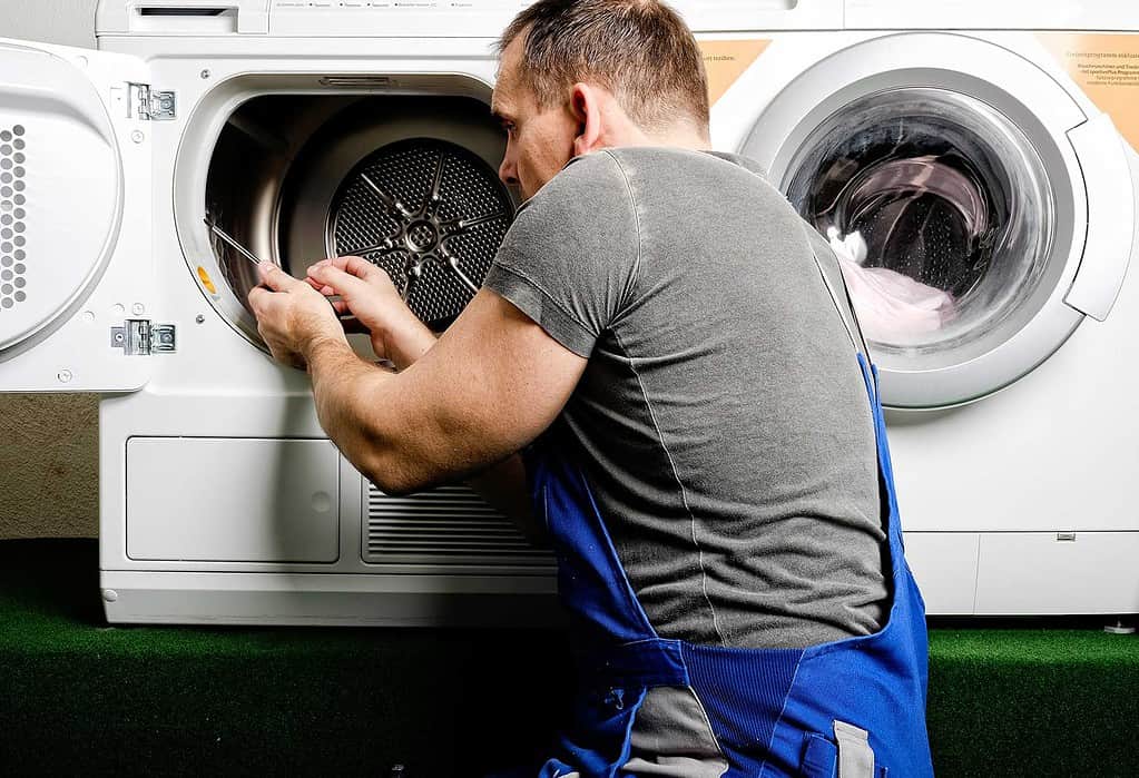 mississauga dryer repair -  man repairing a dryer - dial an applianceman